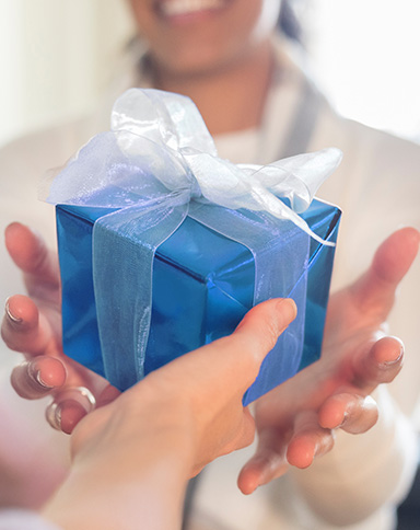 women giving each other a gift from a Boyd retail location